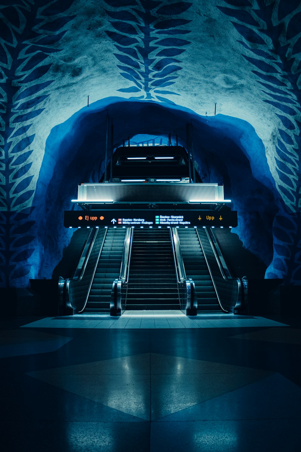 black and gray escalator in a tunnel