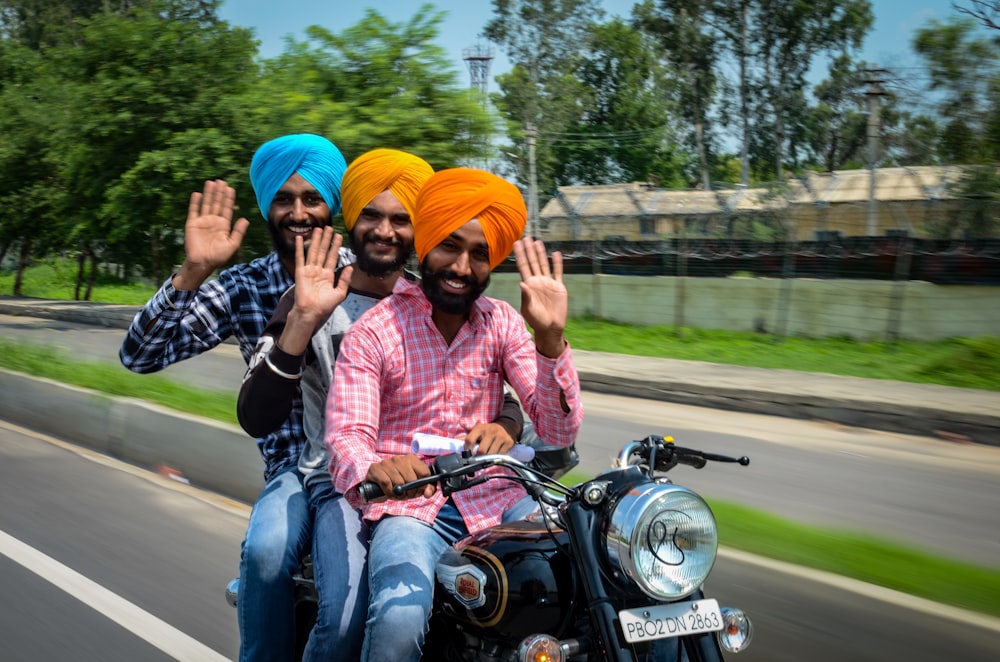 people riding motorcycle on road during daytime