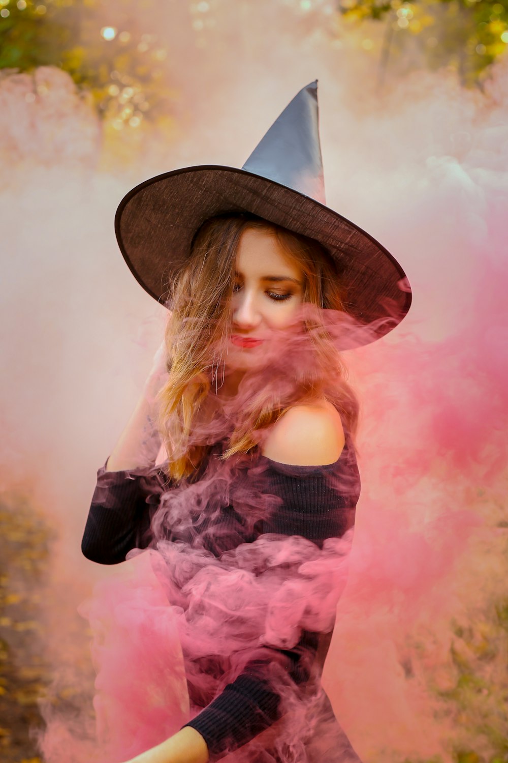 woman in black and pink floral dress wearing brown hat