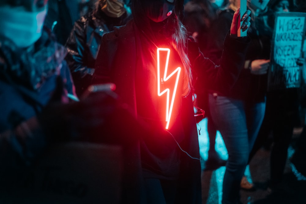 woman in red and white star print hoodie standing on stage