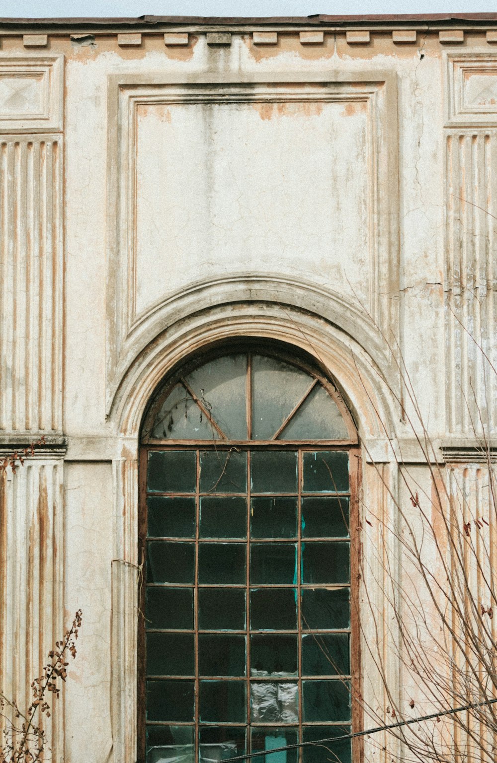 brown wooden window frame on white concrete building