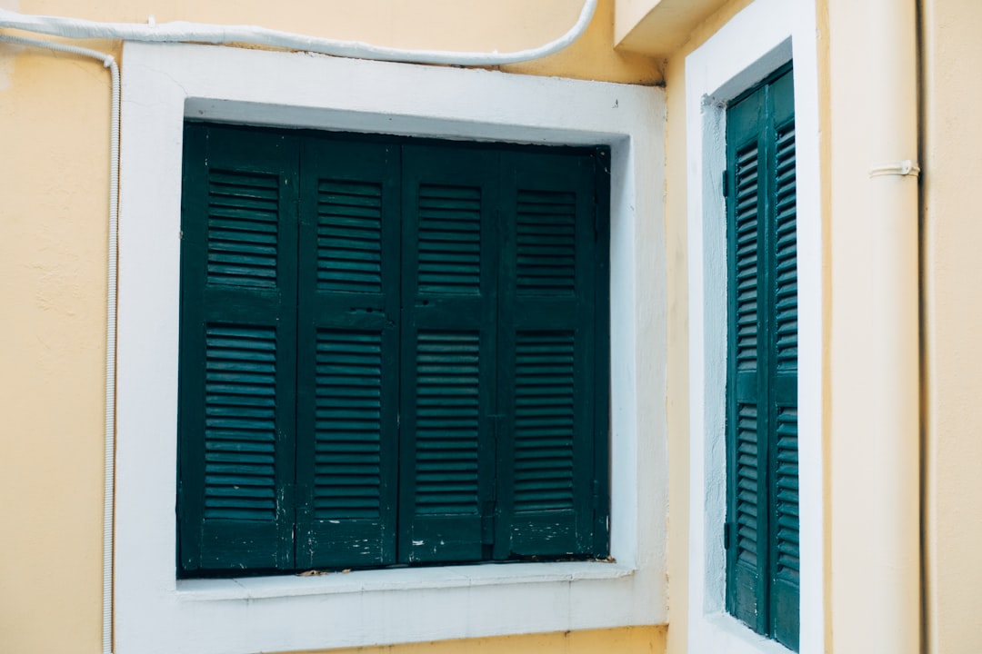 black wooden window on white concrete wall