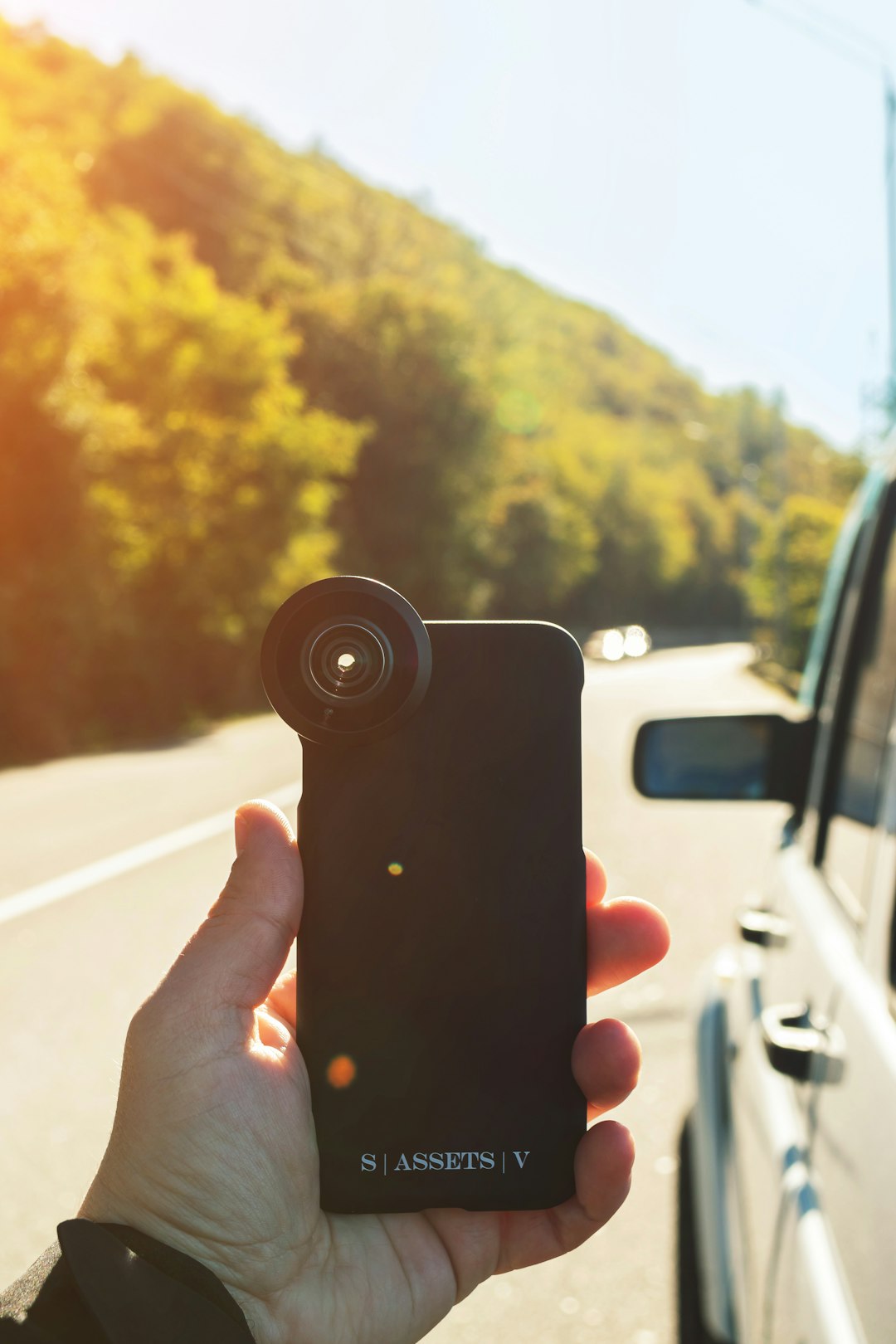 person holding black iphone case