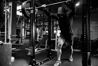 a man is doing a pull up in a gym