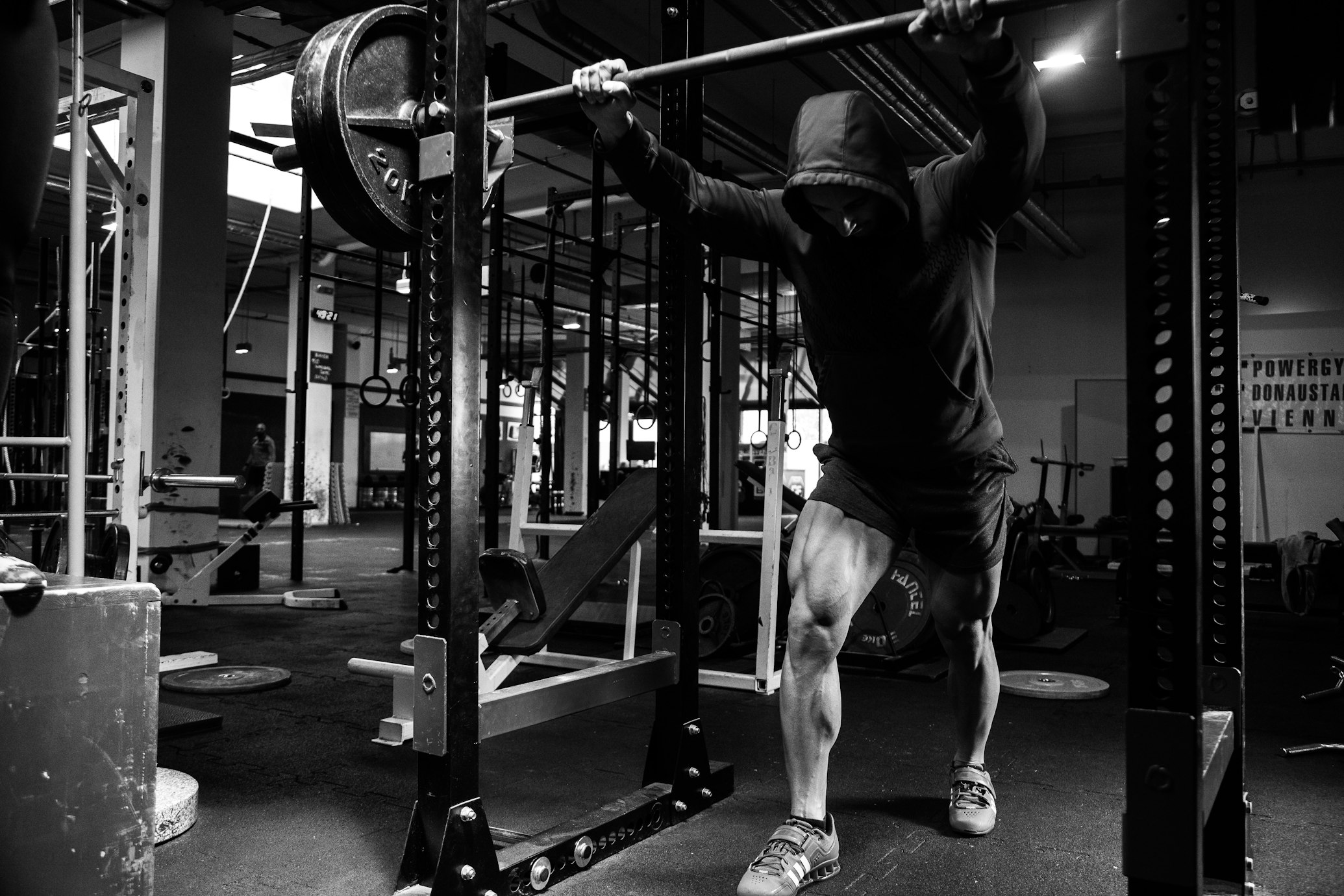 Shirtless man doing squats