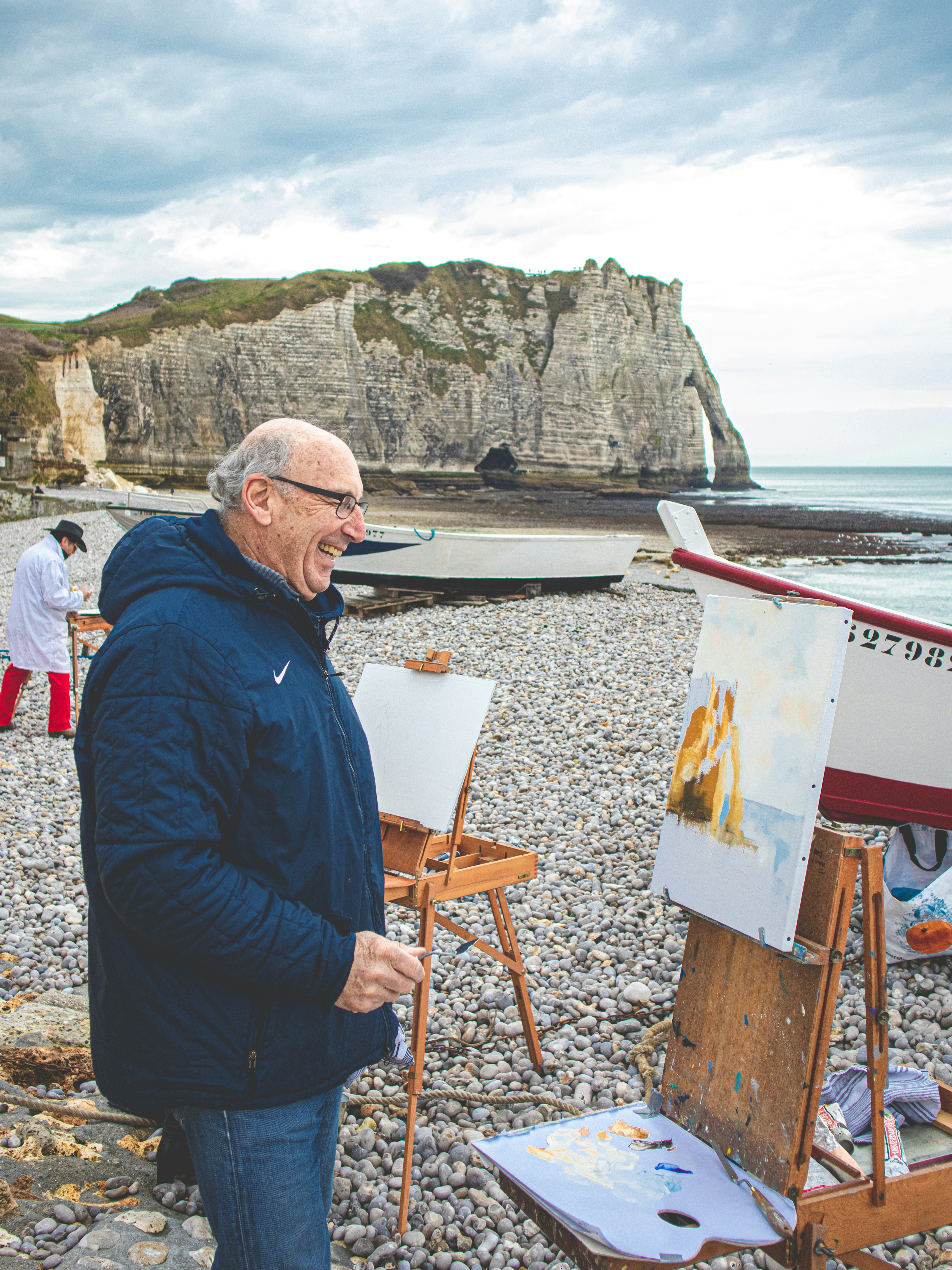 man in black jacket sitting on brown wooden chair