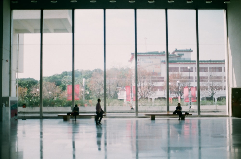 people walking on white floor tiles during daytime