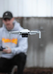 Close-up of a professional drone pilot controlling a drone against a dark background.