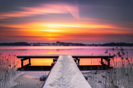 snow covered field during sunset