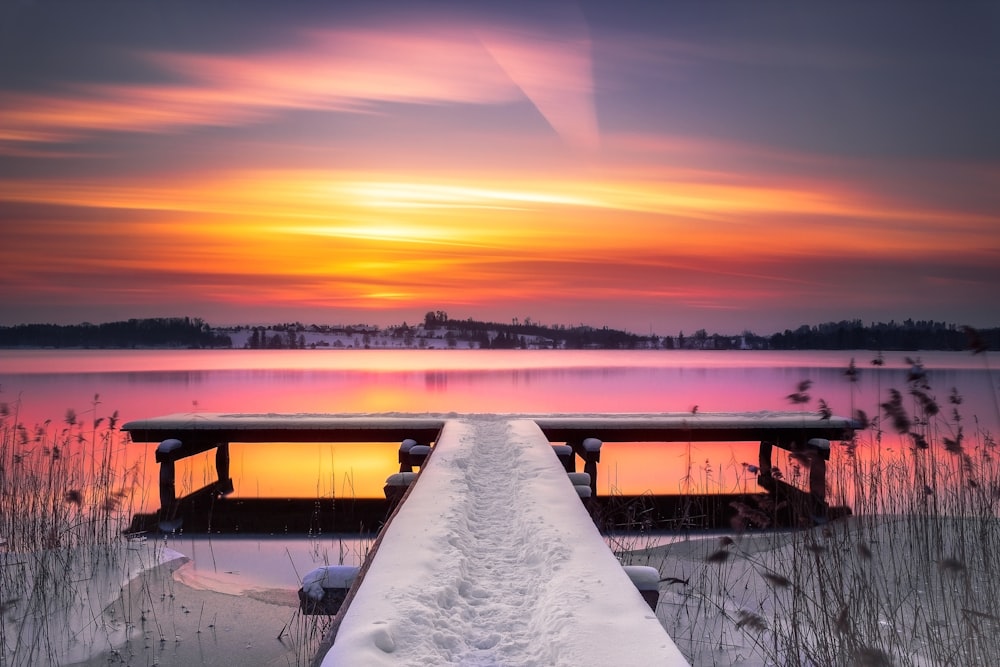 snow covered field during sunset