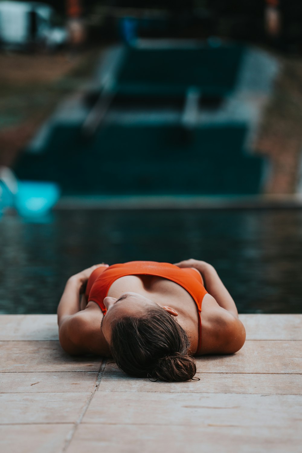 woman in red bikini lying on brown wooden floor