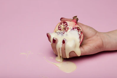 person holding white and red heart shaped ornament