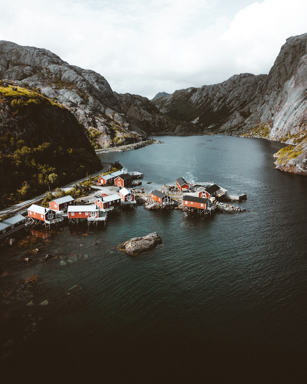 boats on river near mountain during daytime