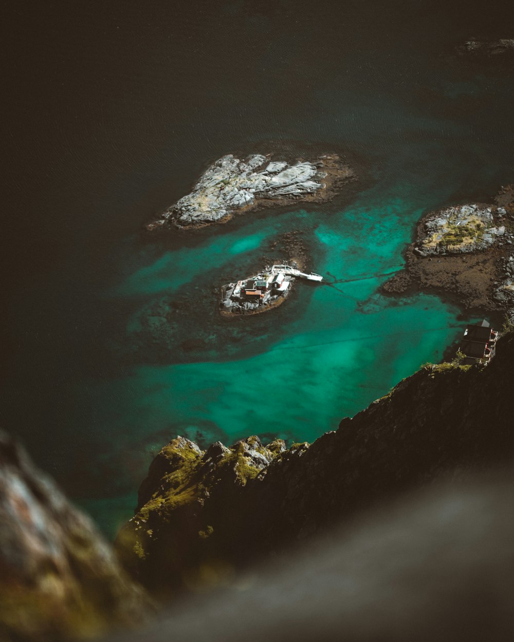 person in black wetsuit swimming on blue water during daytime