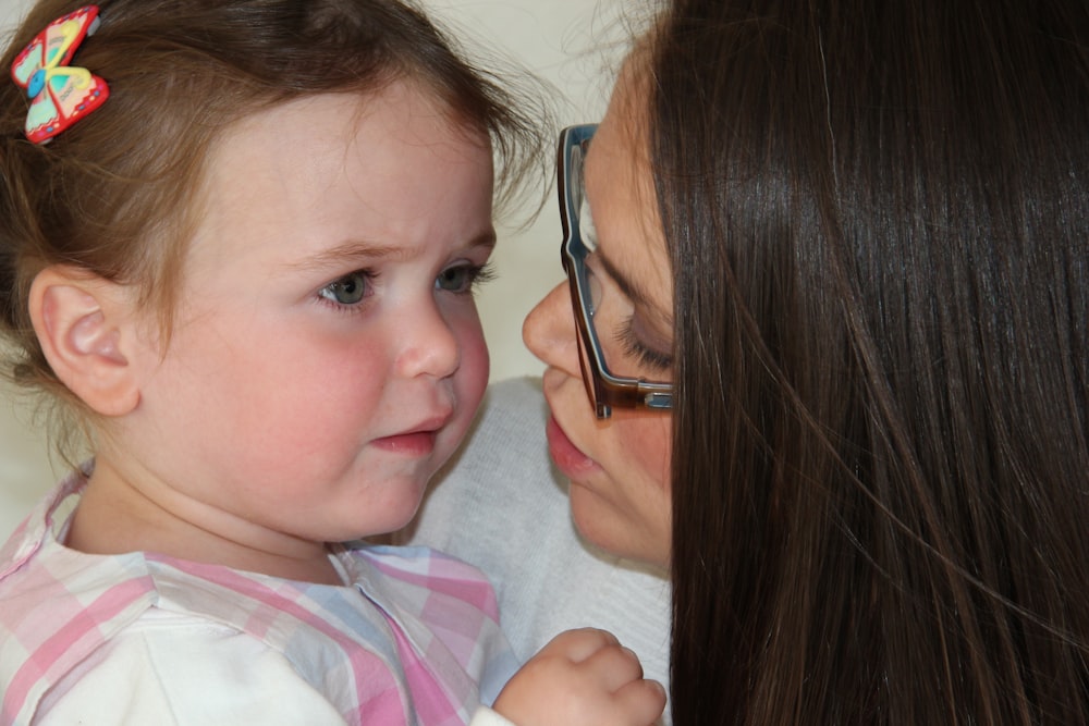 girl in white and pink stripe shirt wearing eyeglasses