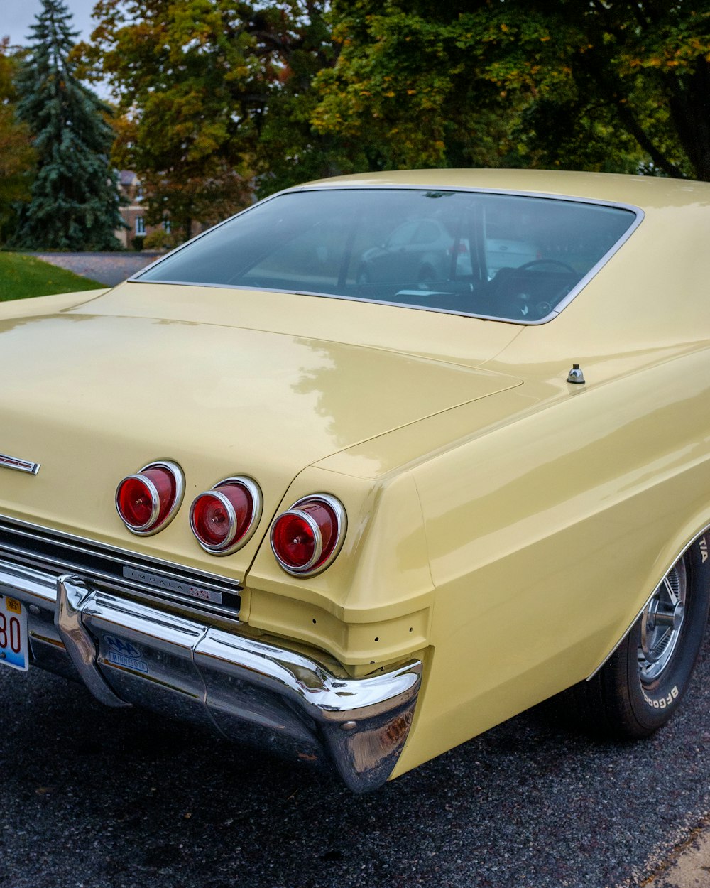 white classic car parked on green grass field during daytime