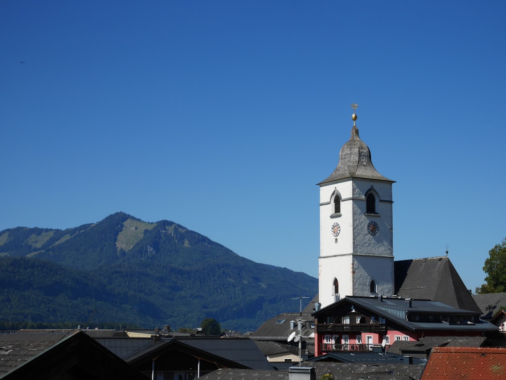 white concrete church near mountain under blue sky during daytime