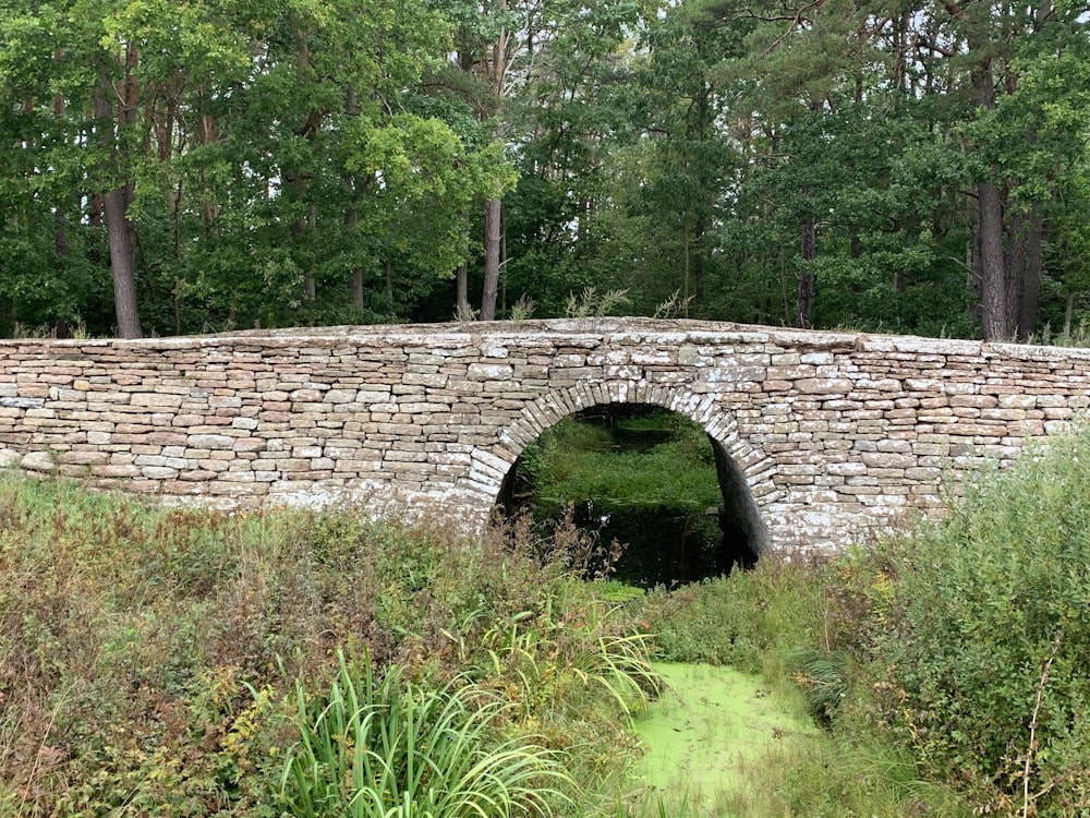 brown brick bridge over green grass field