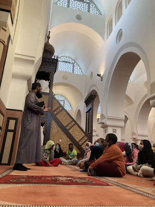 A colorful illustration of children gathered around a storyteller sharing Quranic stories.