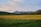 An aerial view of a picturesque field with mountains in the background.