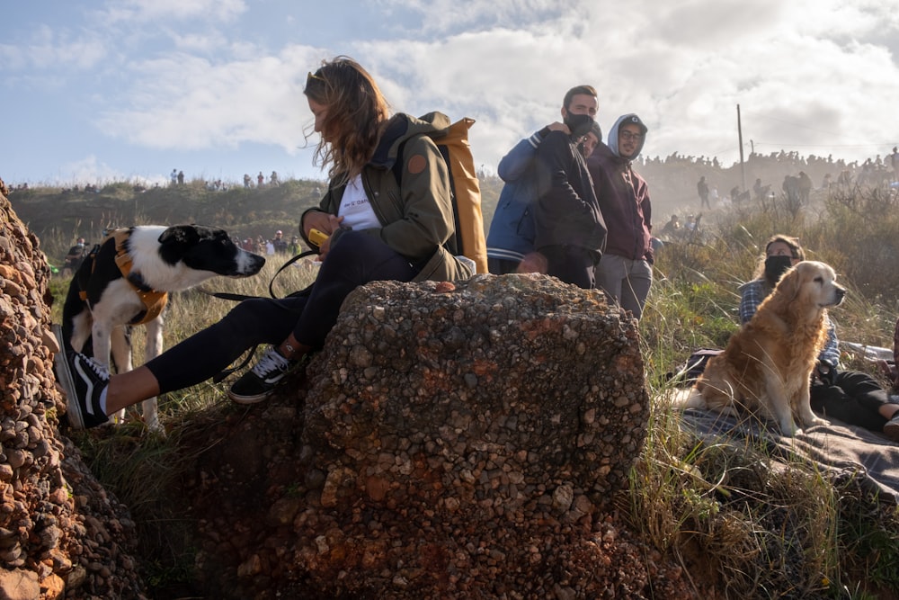 people sitting on rock during daytime