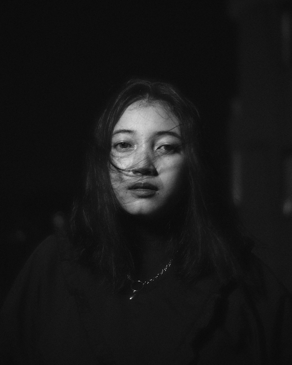 woman in black shirt with silver necklace