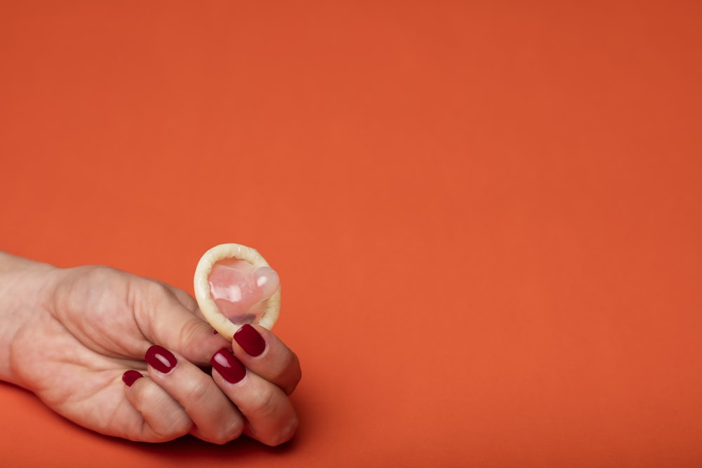 person holding white round ornament