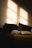 A serene person reading a blog on a cozy couch with soft natural light.