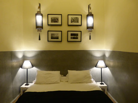 A bright, neatly arranged bedroom with modern furniture and soft lighting.