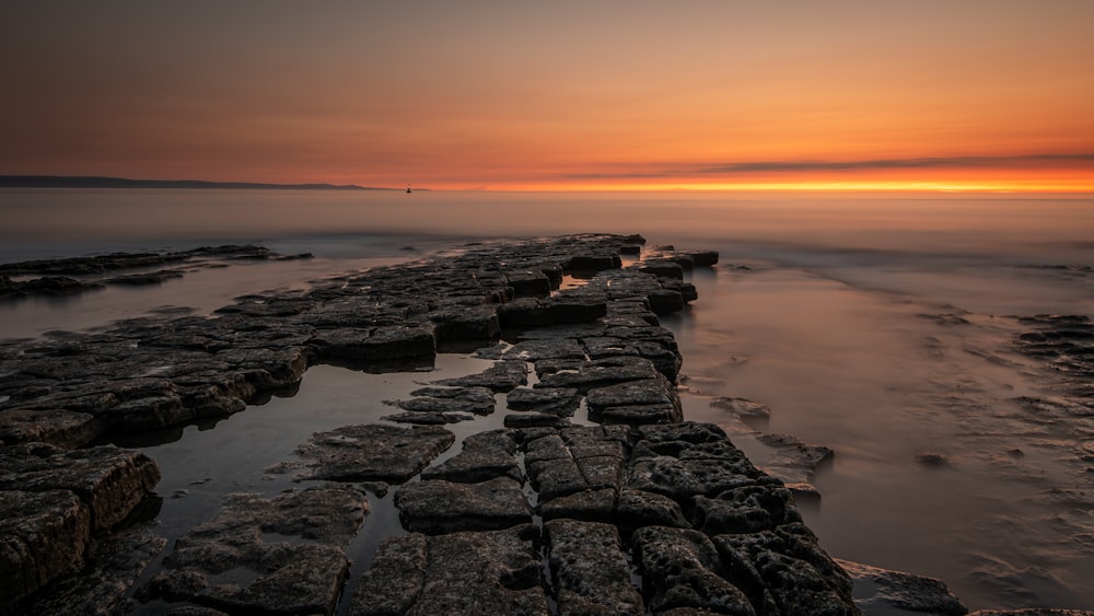 gray rocky shore during sunset