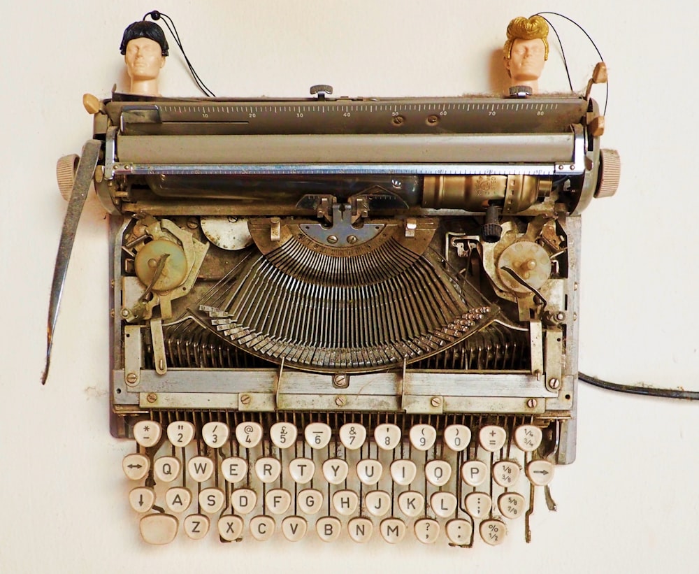 black and gray typewriter on white table