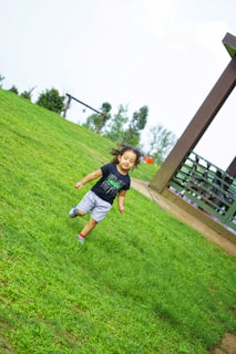 A happy child playing barefoot on a treated lawn, highlighting the family-safe aspect of the service.