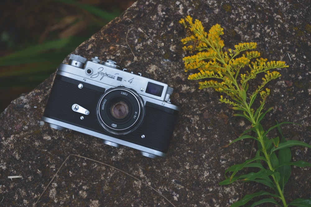 black and silver camera on black and gray marble table