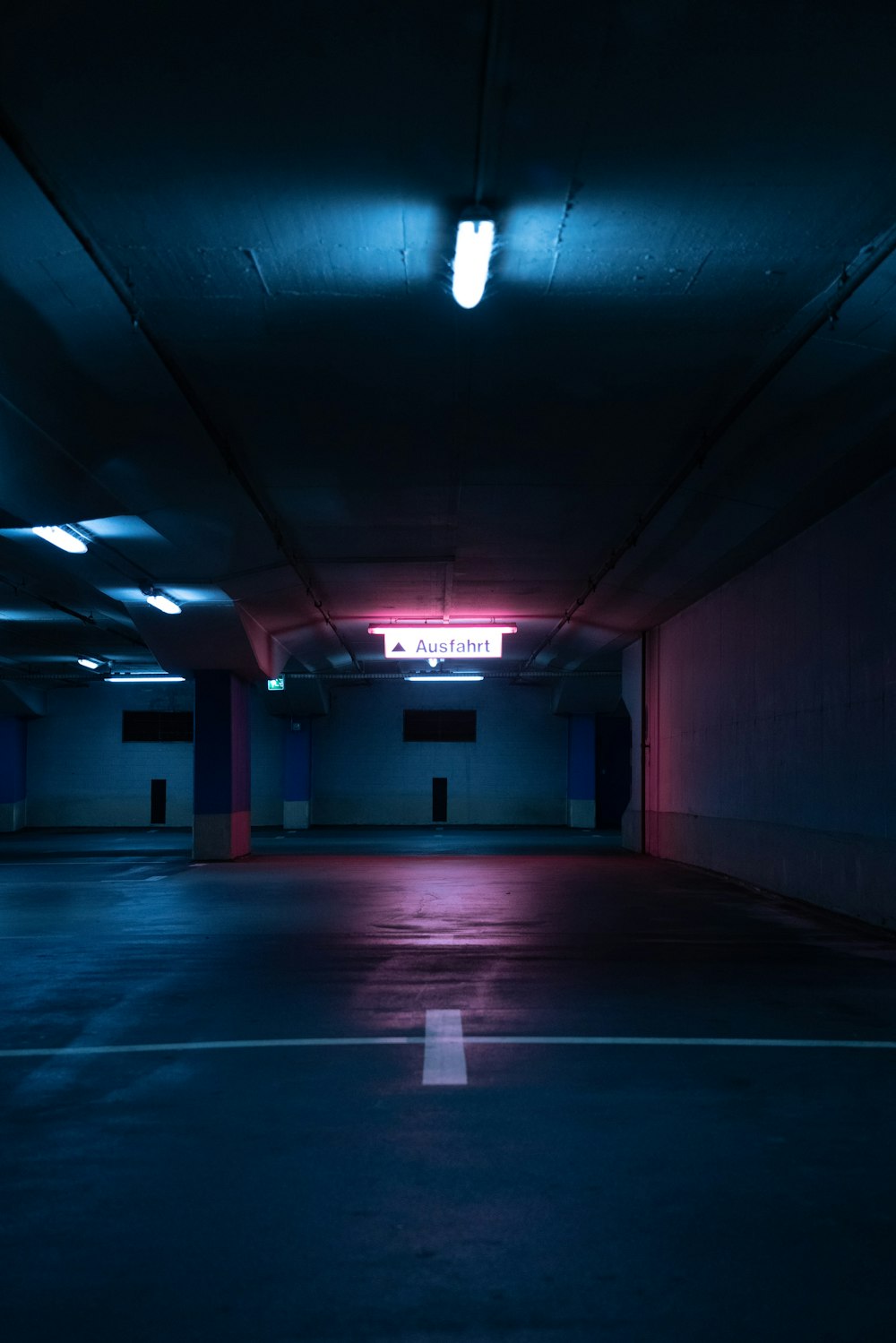 white and blue hallway with lights turned on in room