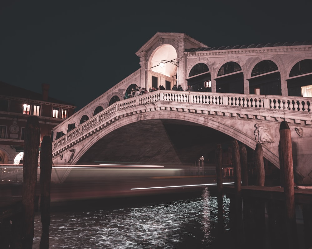 brown concrete bridge over river during night time