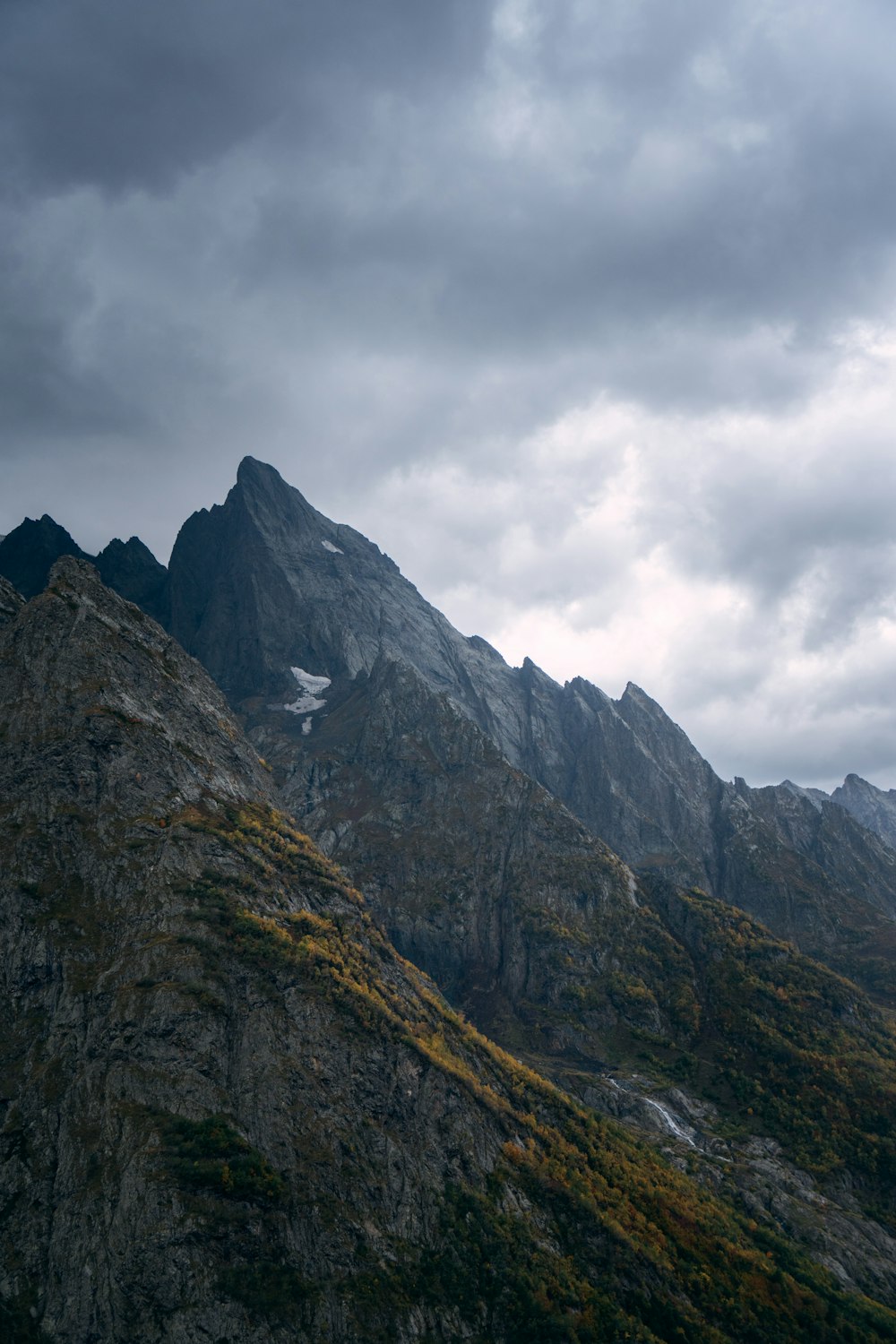 gray rocky mountain under white cloudy sky during daytime