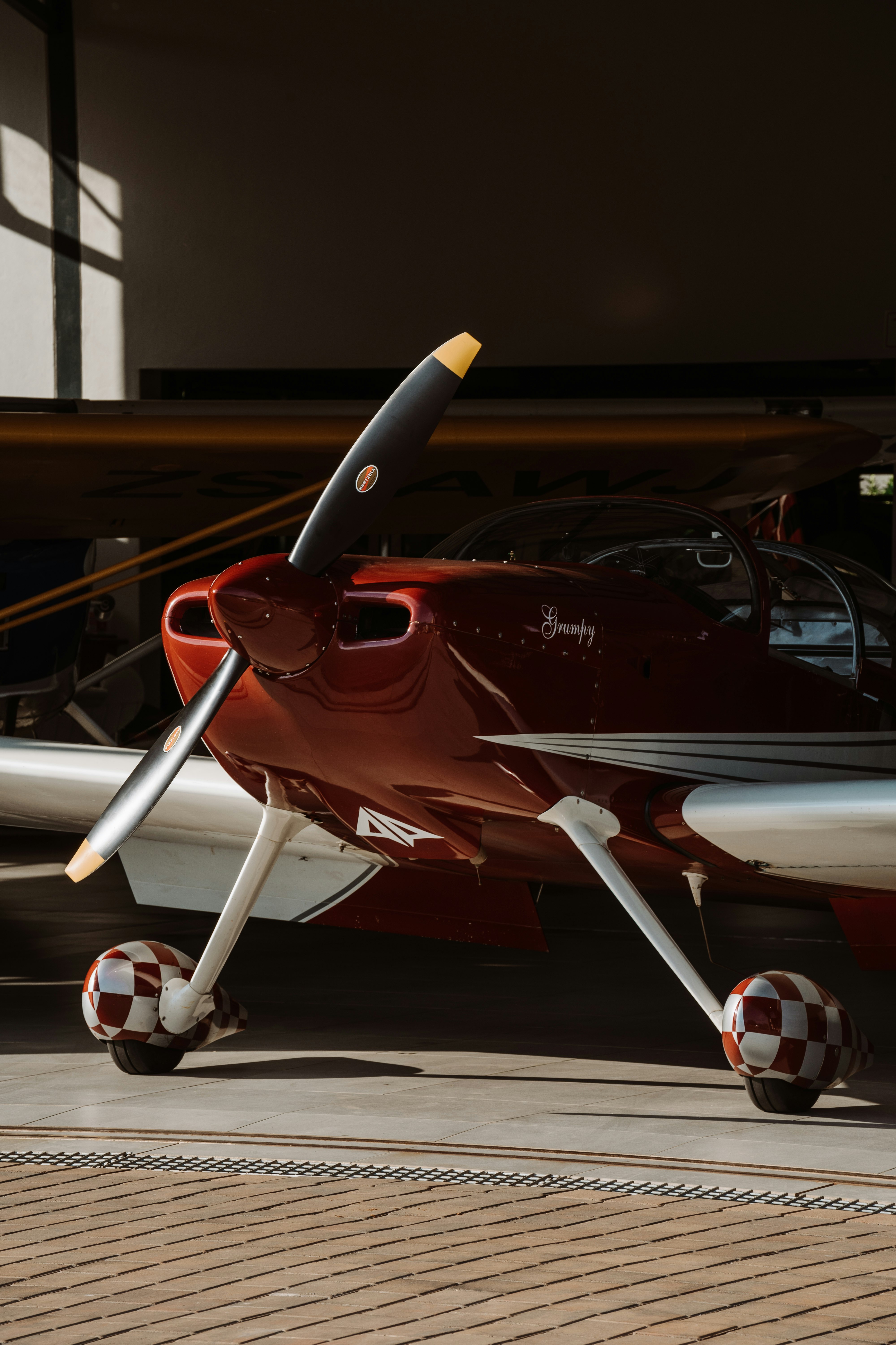 red and white airplane in a parking lot