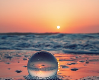 clear glass ball on water during daytime