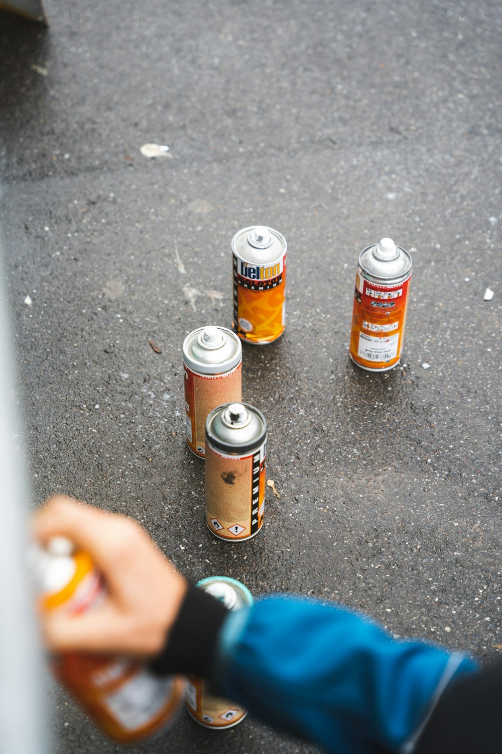 three brown glass bottles on black floor