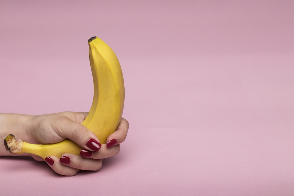 person holding yellow banana fruit