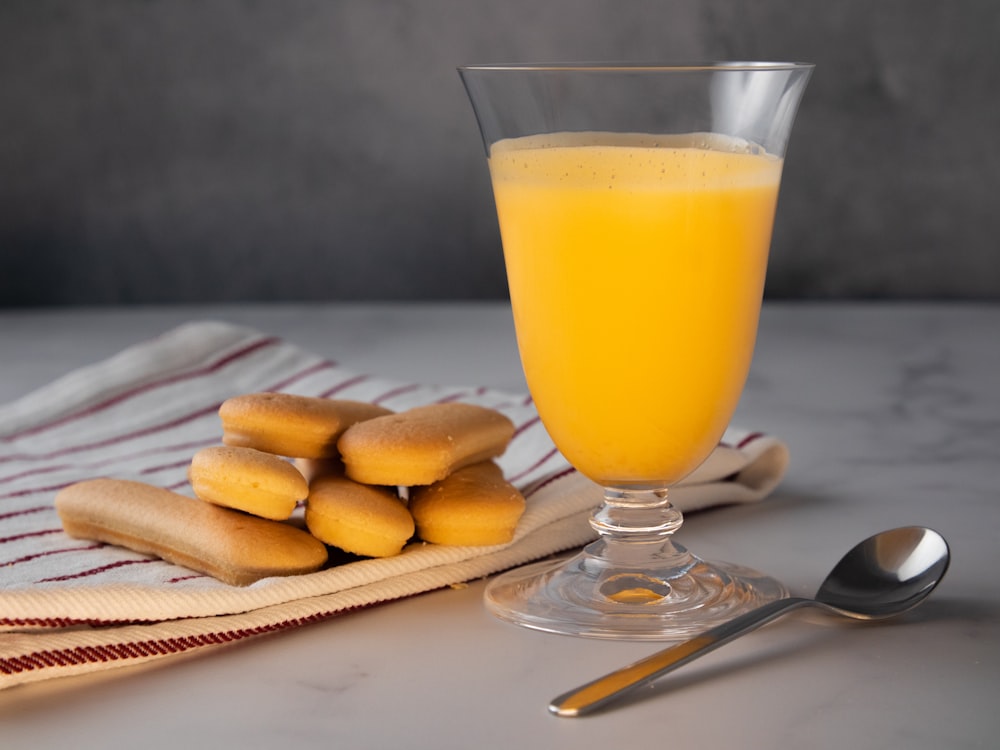 clear drinking glass with yellow liquid