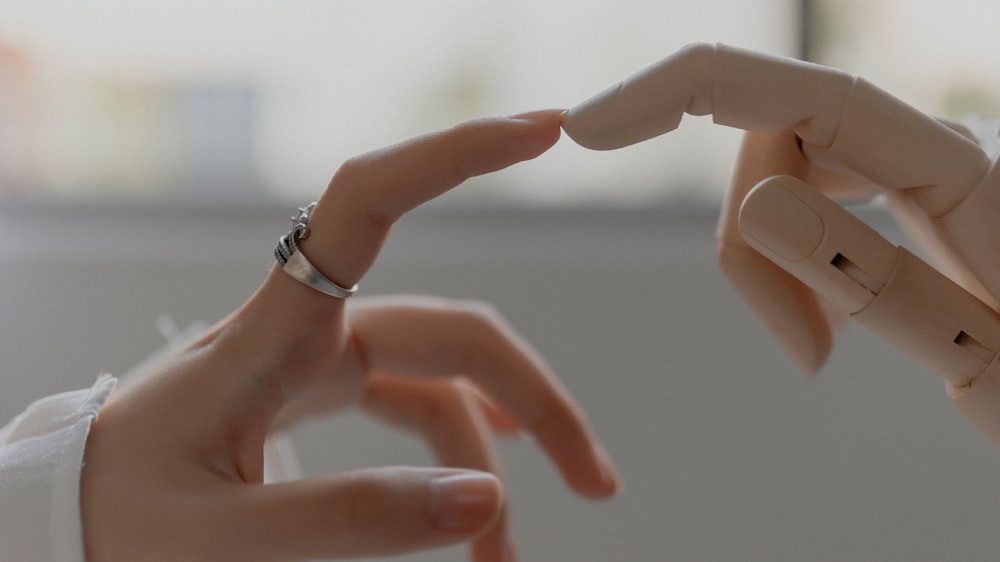 person wearing silver ring with white manicure