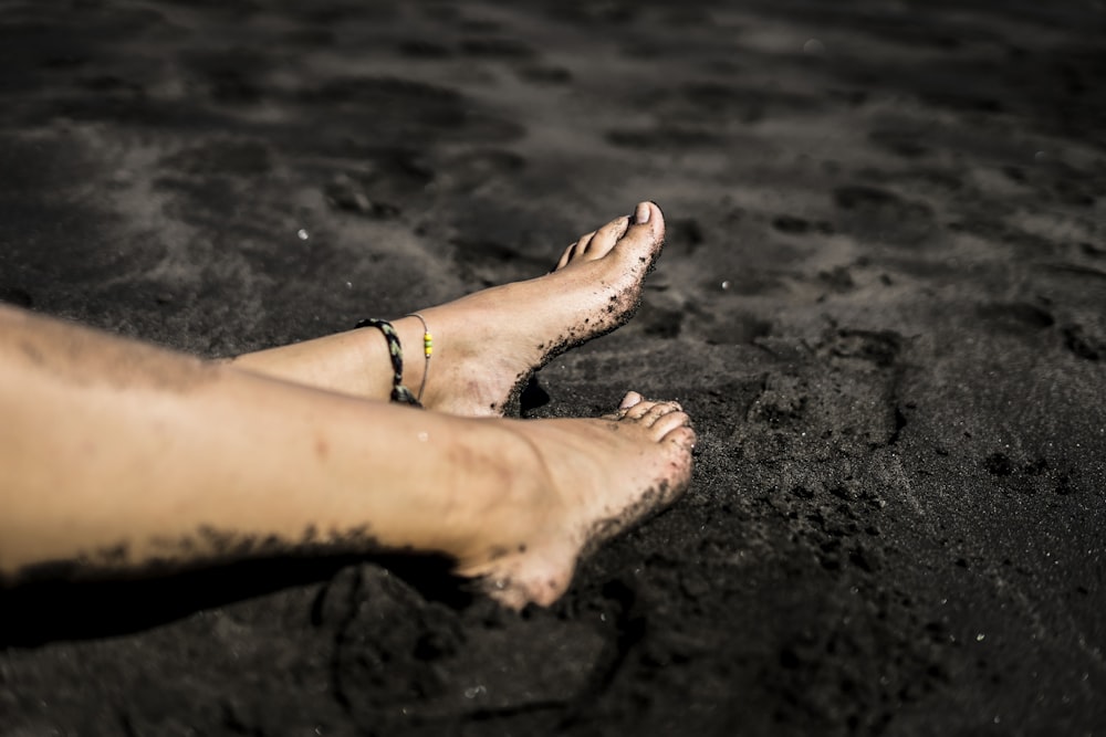 persons feet on beach