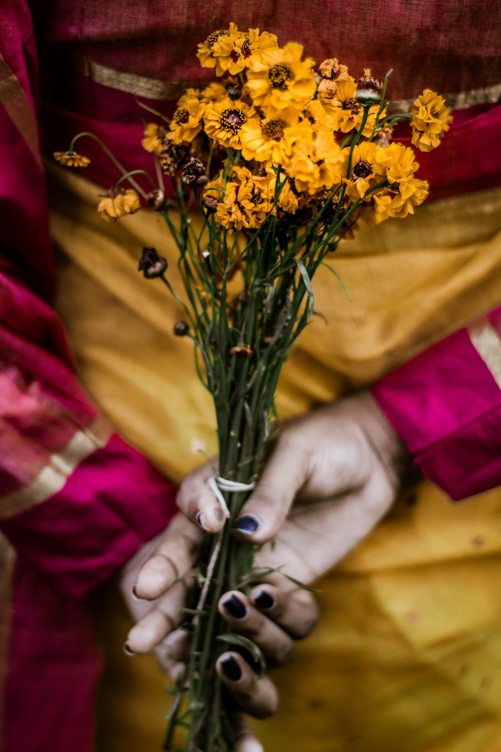 yellow flowers on persons hand