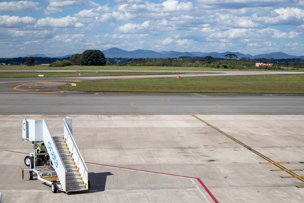 white and blue plane on airport during daytime