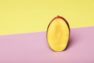 Close-up of a sliced mango revealing its juicy, golden interior on a wooden table.