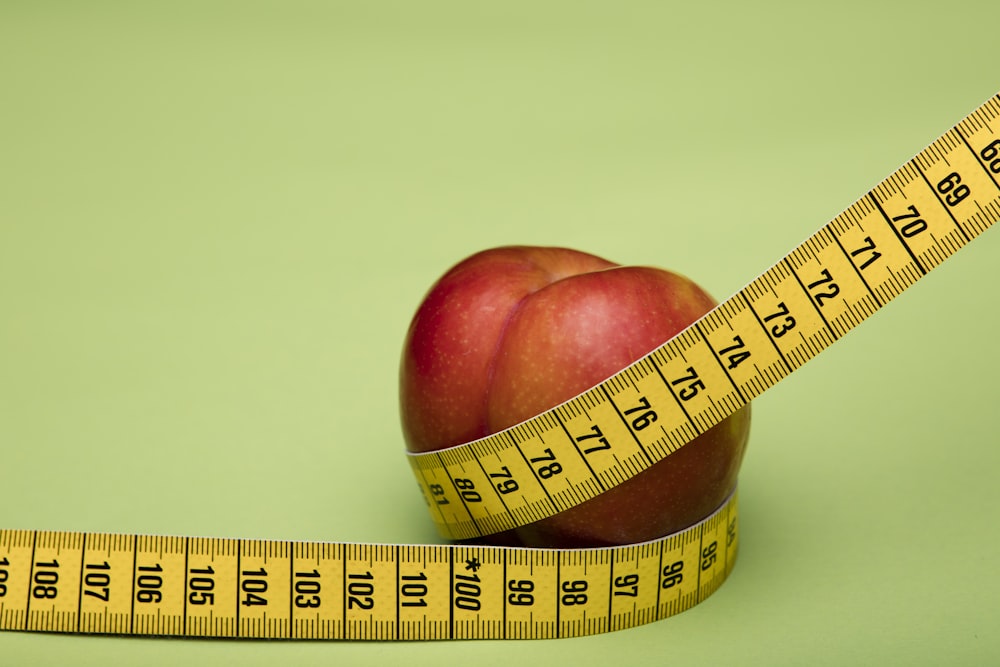 red apple fruit on brown wooden tape