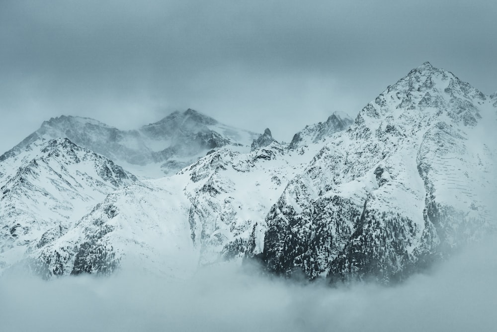 snow covered mountain under cloudy sky