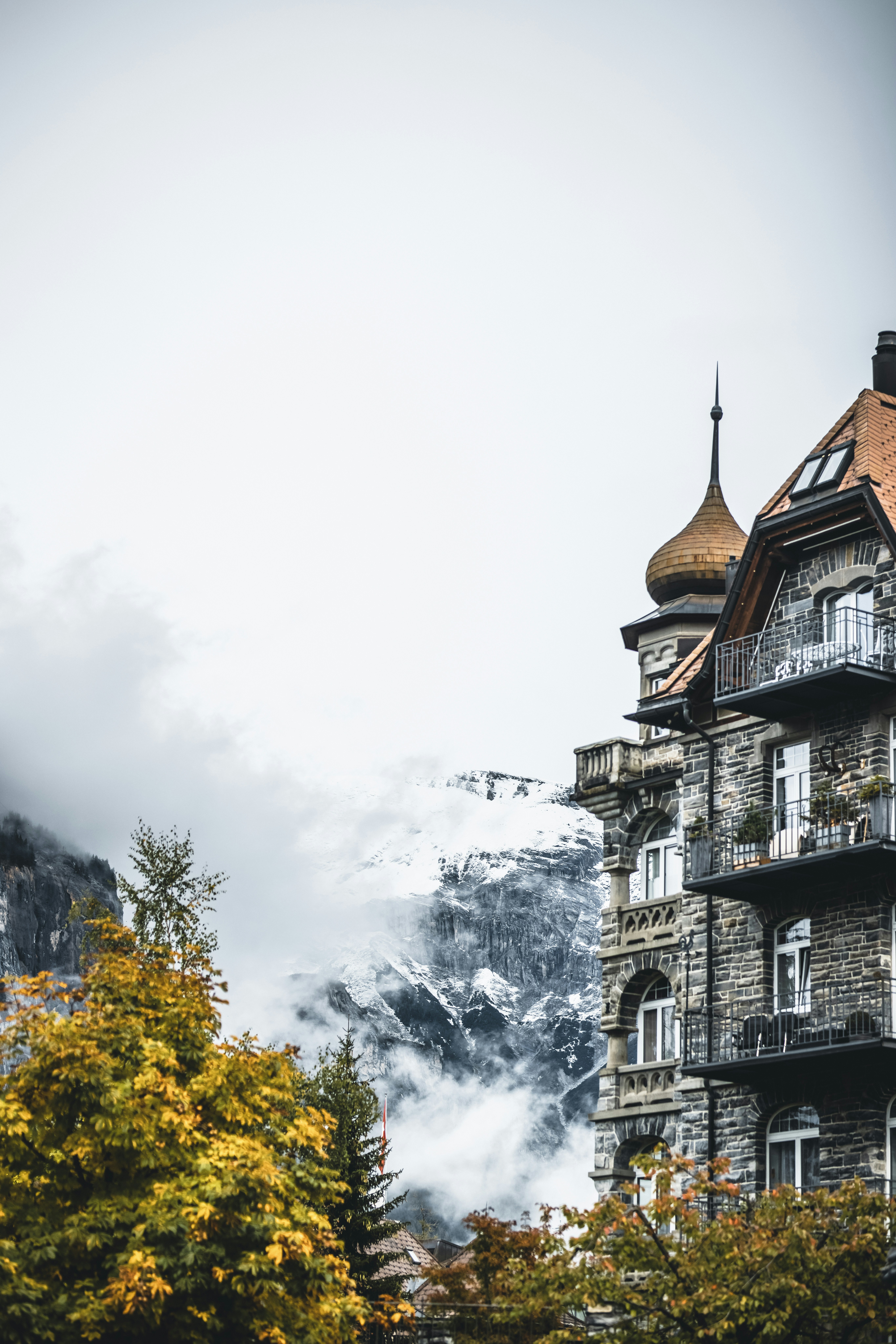 brown and white concrete building under white clouds during daytime