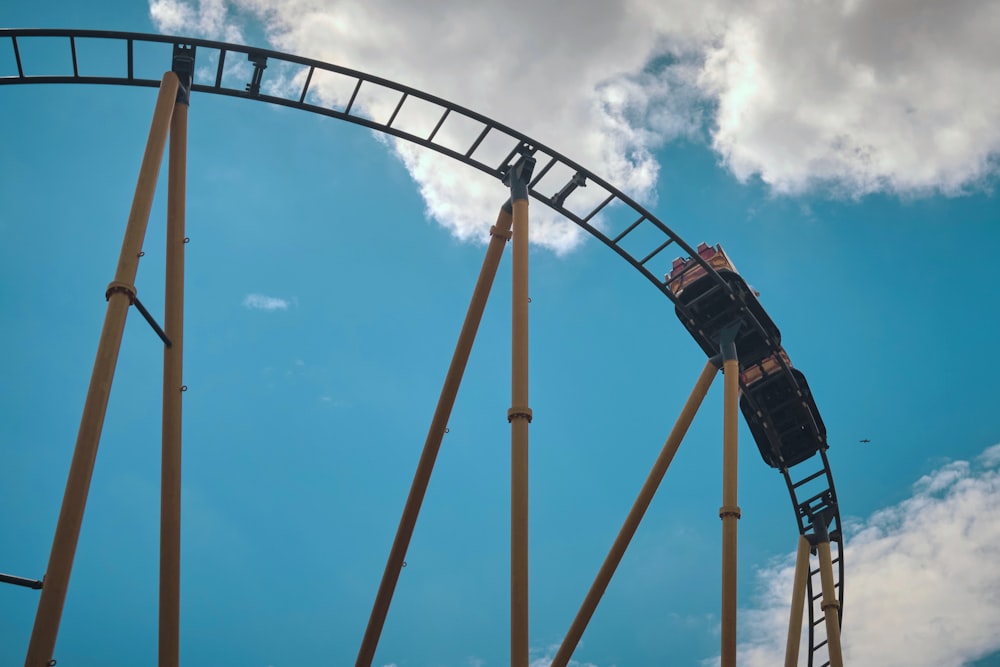 black and red roller coaster under blue sky during daytime